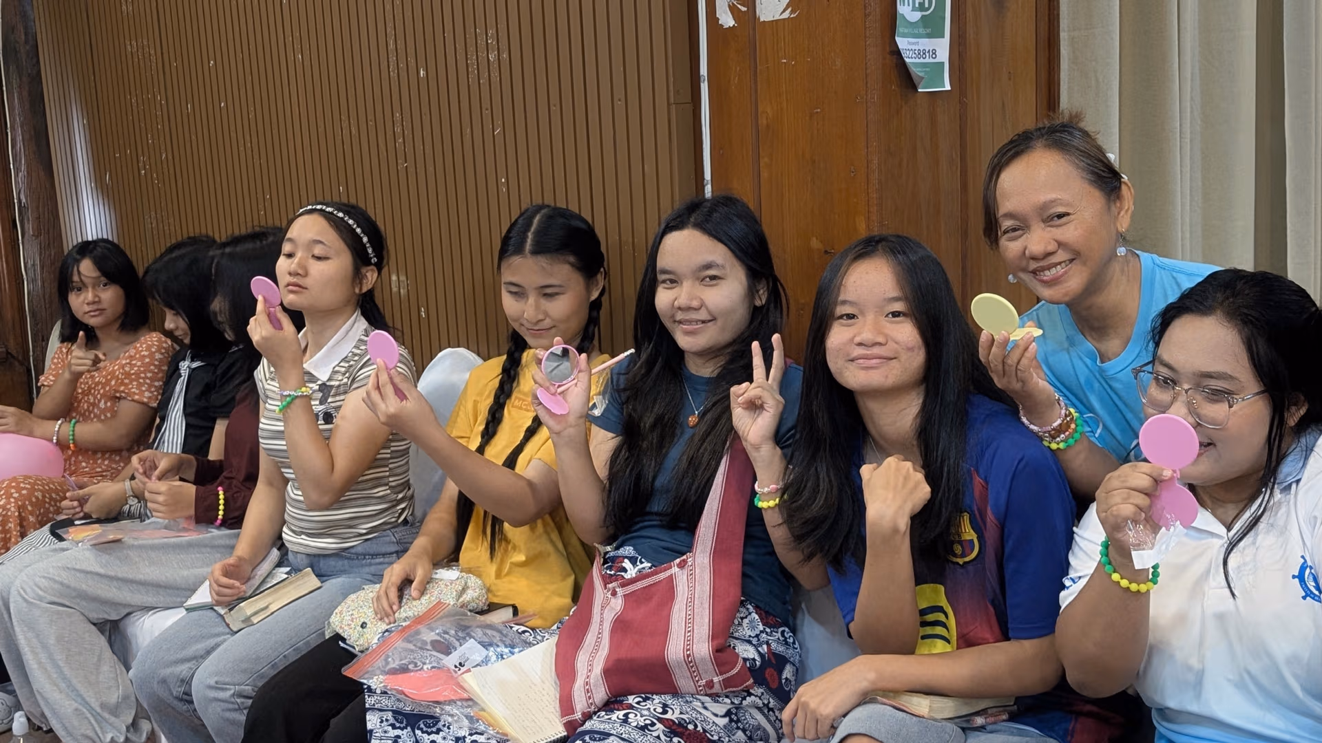 Girls holding their mirrors from the lesson